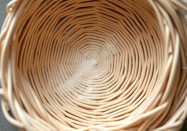 Natural cane proofing basket with planetary ring patterns